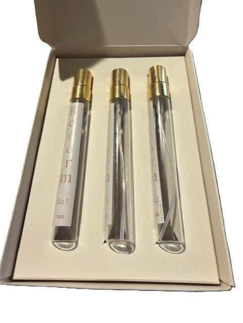 Open Reform gift box displaying three 10ML travel perfume pens in a fitted cream insert.